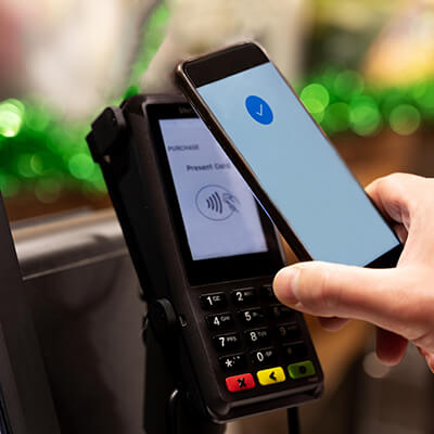 Close up of contactless payment with smart phone at the point of sale